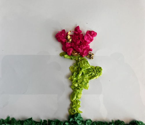 A flower made from little bits of crumpled paper. Dark green line at the bottom with a light green stem and a bright pink flower